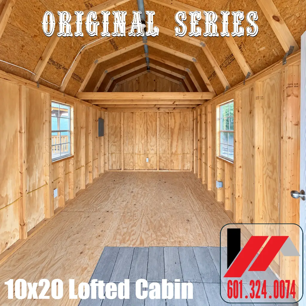 Unfinished 10x20 lofted cabin interior showing exposed wood framing, an overhead loft, plywood flooring, two windows, and electrical wiring.